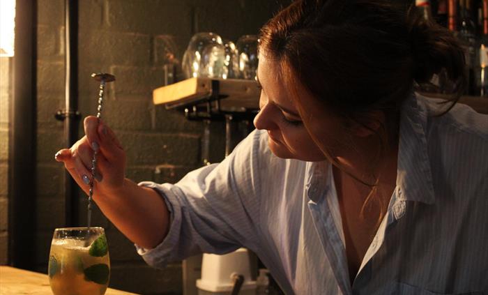 Mojito being stirred on the bar by our head distiller at Spirit of Wales Distillery